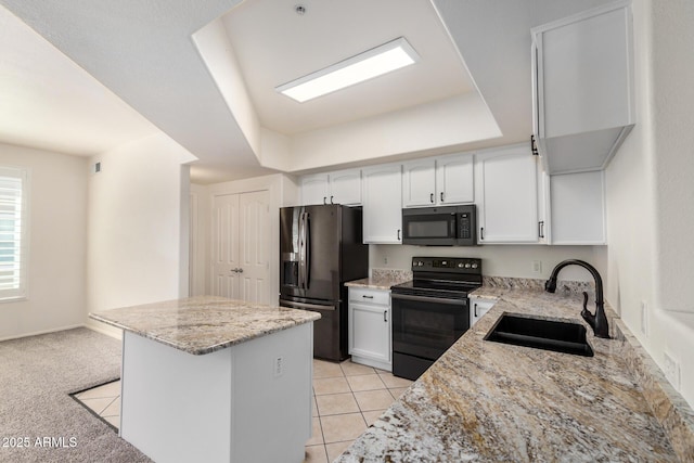 2401 E Rio Salado Pkwy Unit 1048, Tempe, AZ 85288 - kitchen featuring black appliances, a center island, light stone countertops, white cabinetry, and a raised ceiling