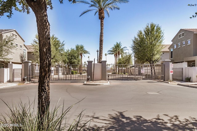 2401 E Rio Salado Pkwy Unit 1048, Tempe, AZ 85288 - view of asphalt road featuring a gate, curbs, sidewalks, a gated entry, and a residential view