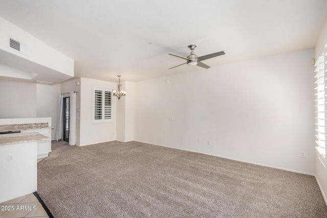 2401 E Rio Salado Pkwy Unit 1048, Tempe, AZ 85288 - unfurnished living room with light colored carpet, a ceiling fan, and a chandelier