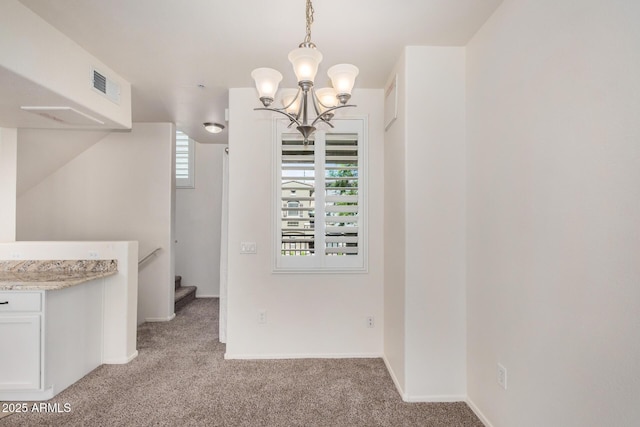 2401 E Rio Salado Pkwy Unit 1048, Tempe, AZ 85288 - unfurnished dining area featuring light carpet and a chandelier