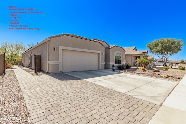 view of front of property featuring a garage, driveway, a tiled roof, and stucco siding