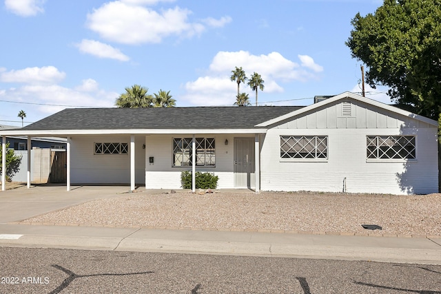 ranch-style house featuring a carport