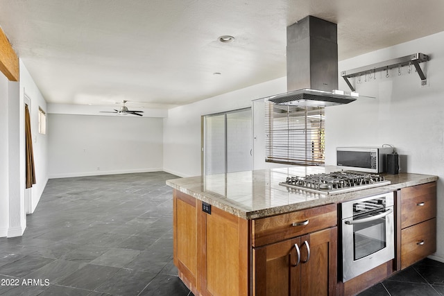 kitchen with ceiling fan, stainless steel appliances, and island range hood