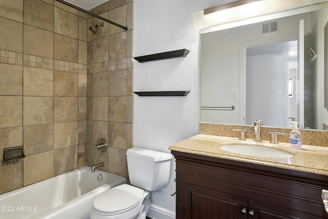 full bathroom featuring toilet, vanity, and tiled shower / bath