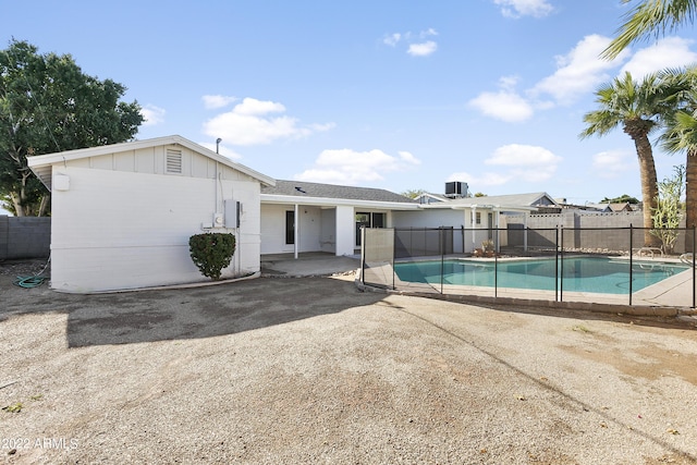 view of pool featuring cooling unit and a patio area