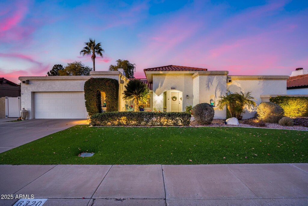 6320 E Kings Ave, Scottsdale, AZ 85254 - view of front of house featuring a garage and a lawn