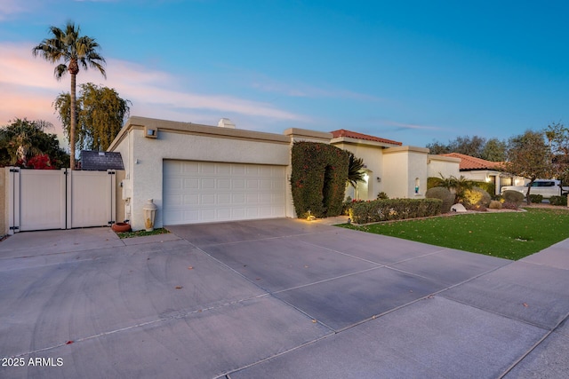 view of front of home featuring a garage and a yard