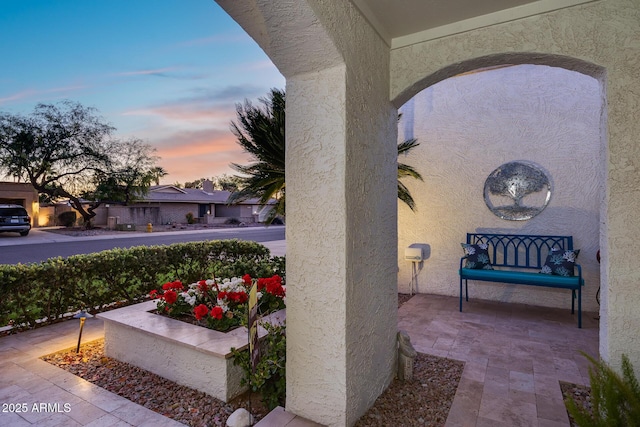 view of patio terrace at dusk