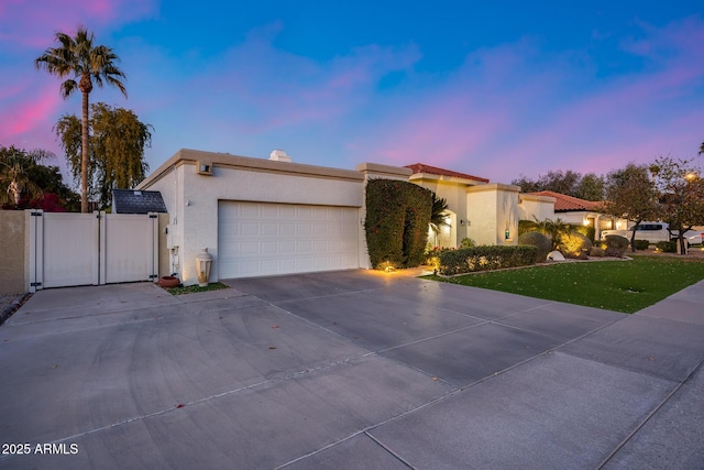 view of front facade with a garage and a yard