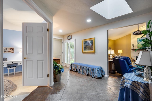 bedroom featuring lofted ceiling with skylight