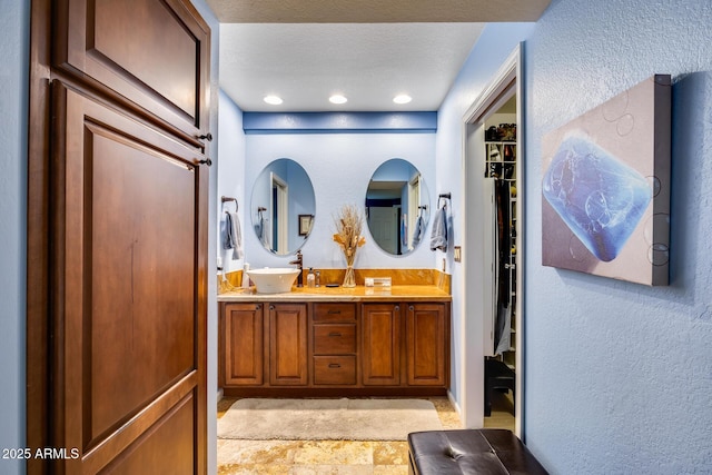 bathroom with vanity and a textured ceiling