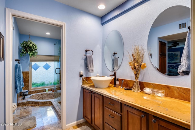 bathroom featuring vanity, toilet, and walk in shower