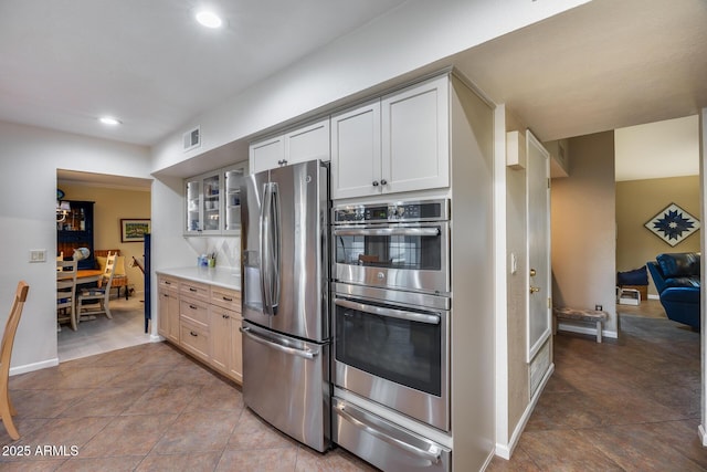 kitchen with white cabinetry, tile patterned flooring, and stainless steel appliances