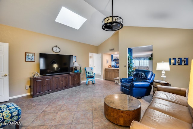 tiled living room featuring a skylight and high vaulted ceiling