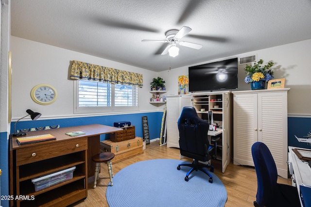 office area featuring ceiling fan, wood-type flooring, and a textured ceiling