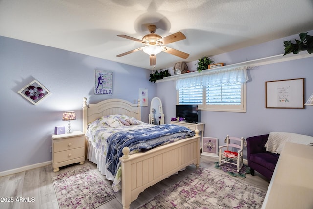 bedroom with light hardwood / wood-style flooring and ceiling fan