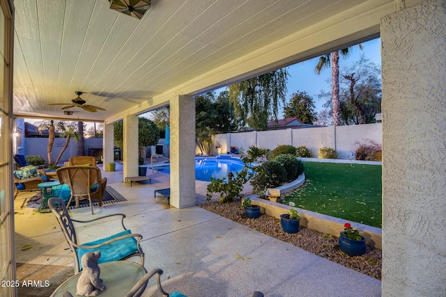 view of patio / terrace featuring a fenced in pool and ceiling fan