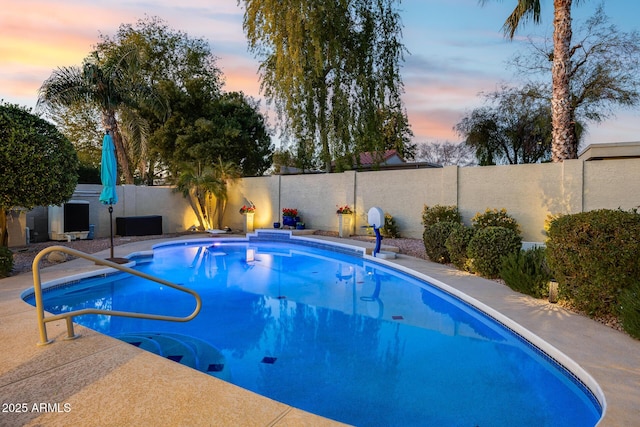 view of pool at dusk