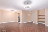 unfurnished living room with dark hardwood / wood-style flooring