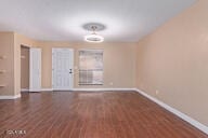 unfurnished room featuring dark hardwood / wood-style floors