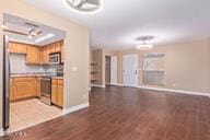 kitchen with backsplash, light hardwood / wood-style floors, and stainless steel range oven