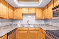 kitchen with backsplash, stainless steel appliances, a raised ceiling, and sink