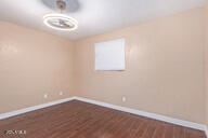 empty room with dark wood-type flooring