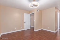 unfurnished room featuring dark wood-type flooring