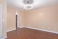 spare room featuring dark wood-type flooring