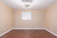 unfurnished room featuring dark hardwood / wood-style flooring