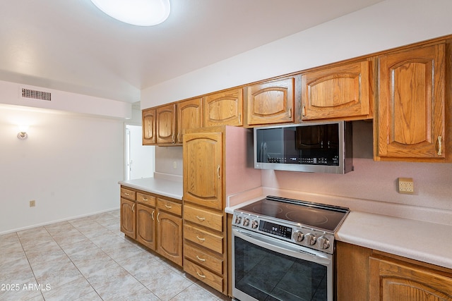 10335 W Mission Ln, Sun City, AZ 85351 - kitchen featuring visible vents, brown cabinets, stainless steel appliances, and light countertops