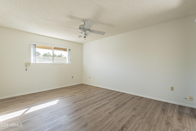10335 W Mission Ln, Sun City, AZ 85351 - unfurnished room featuring a ceiling fan, wood finished floors, baseboards, and a textured ceiling