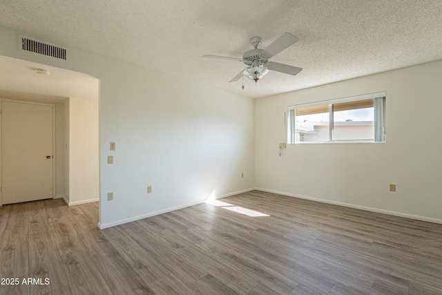 10335 W Mission Ln, Sun City, AZ 85351 - spare room with ceiling fan, visible vents, a textured ceiling, and wood finished floors