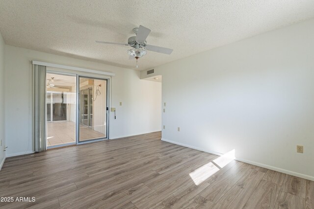 10335 W Mission Ln, Sun City, AZ 85351 - spare room featuring baseboards, a textured ceiling, ceiling fan, and wood finished floors