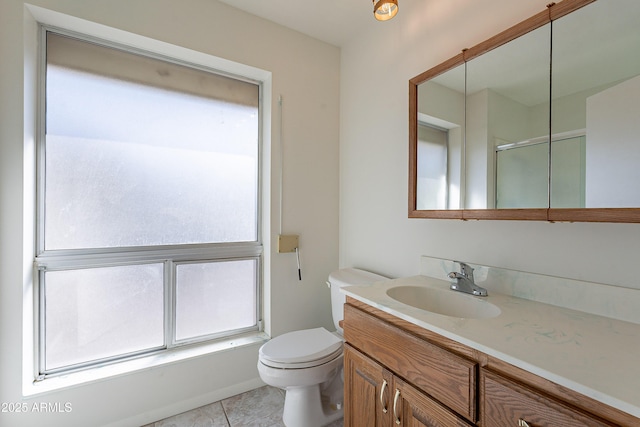 10335 W Mission Ln, Sun City, AZ 85351 - full bathroom featuring vanity, toilet, tile patterned flooring, and a shower with door