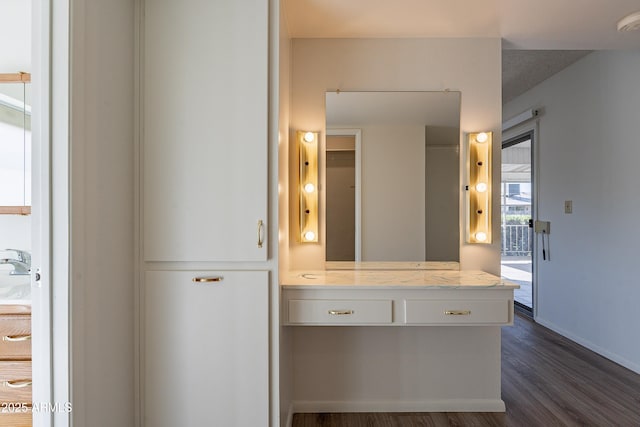 10335 W Mission Ln, Sun City, AZ 85351 - bathroom featuring vanity, baseboards, and wood finished floors