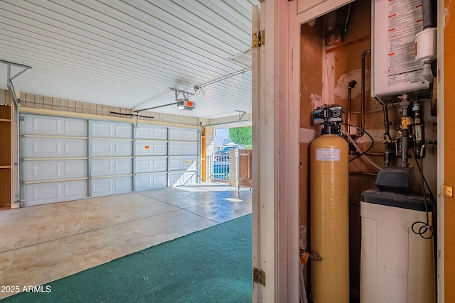 10335 W Mission Ln, Sun City, AZ 85351 - garage with tankless water heater and a garage door opener