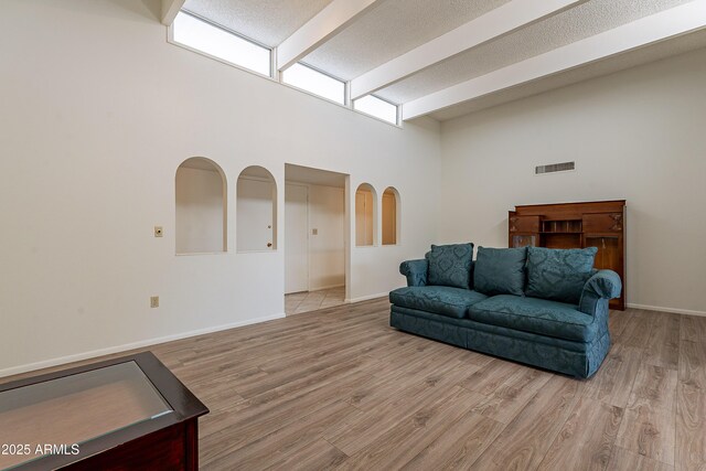 10335 W Mission Ln, Sun City, AZ 85351 - interior space with a towering ceiling, baseboards, visible vents, and light wood finished floors