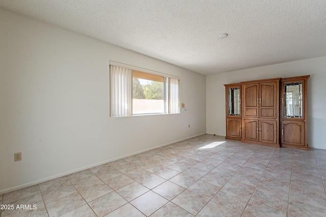 10335 W Mission Ln, Sun City, AZ 85351 - empty room with baseboards and a textured ceiling