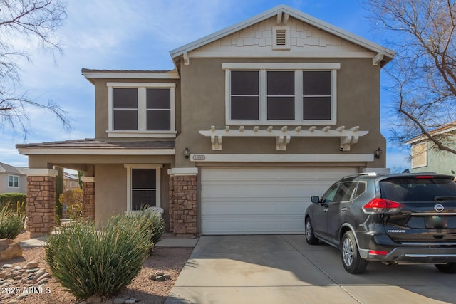 traditional-style home with a garage, concrete driveway, and stucco siding