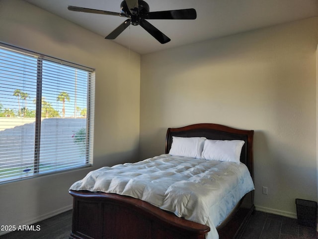 bedroom with dark hardwood / wood-style flooring and ceiling fan