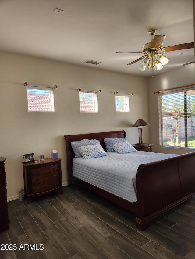 bedroom featuring multiple windows and ceiling fan