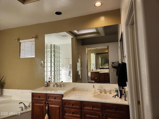 bathroom featuring a tub to relax in and vanity