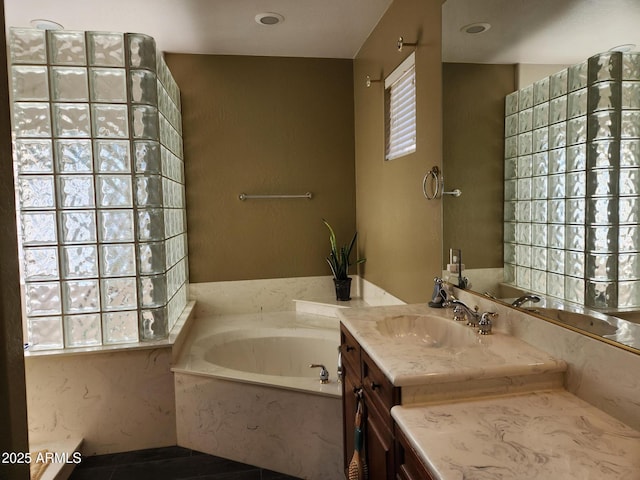 bathroom featuring vanity and a washtub