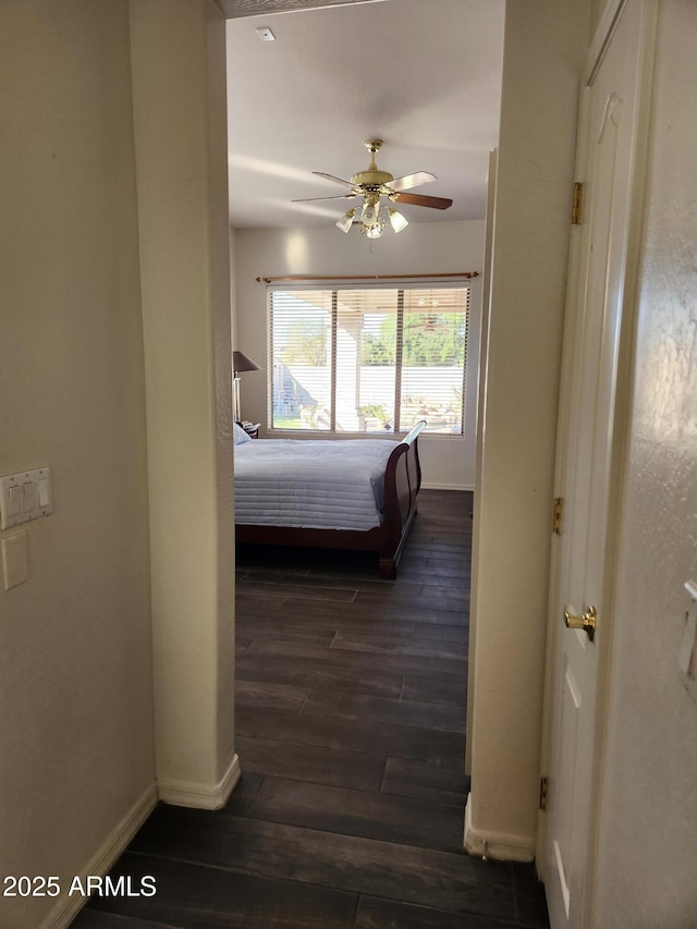 bedroom with dark hardwood / wood-style flooring and ceiling fan