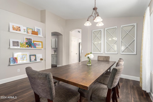 17606 N 2nd Ave, Phoenix, AZ 85023 - dining area featuring arched walkways, baseboards, dark wood-type flooring, and a chandelier