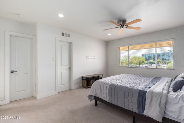 bedroom with light carpet and ceiling fan