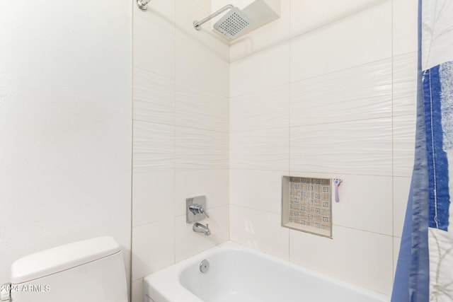 bathroom featuring toilet and shower / tub combo with curtain