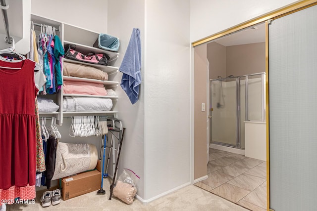 walk in closet featuring carpet floors