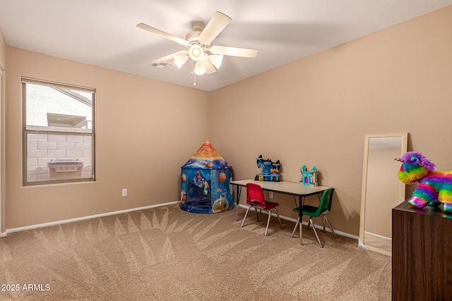 recreation room with carpet floors, ceiling fan, visible vents, and baseboards